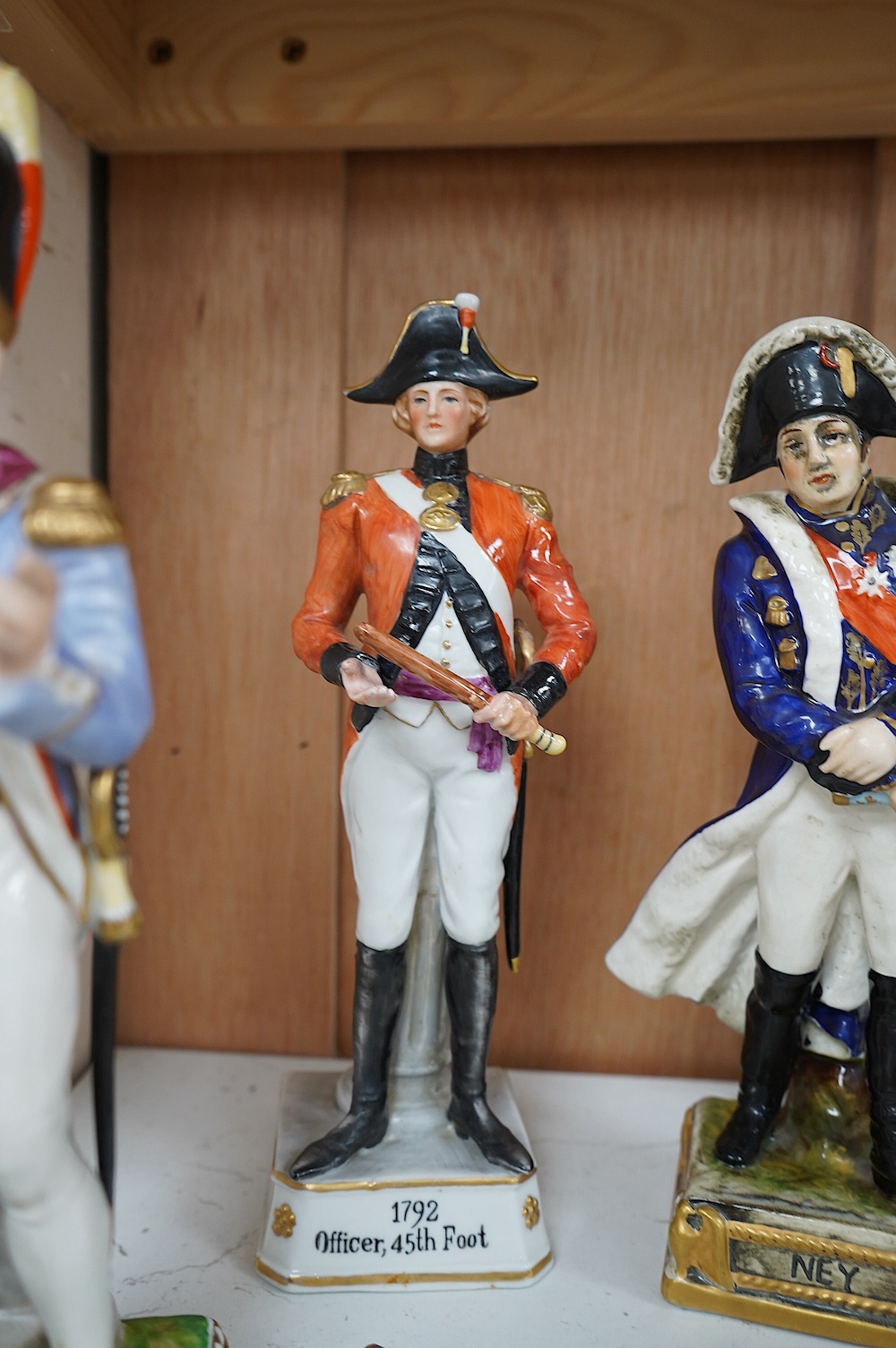 Four Continental porcelain figures wearing military dress including Napoleon and Officer, 45th Foot, largest 23cm high. Condition - good